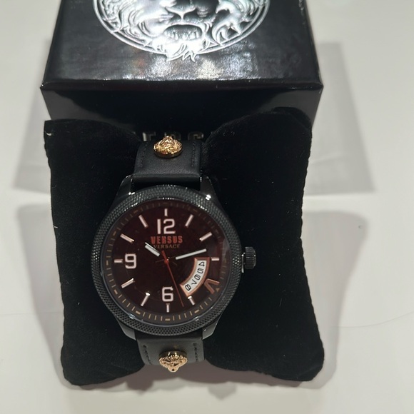 Versace Versus watch with lion head accent on strap.